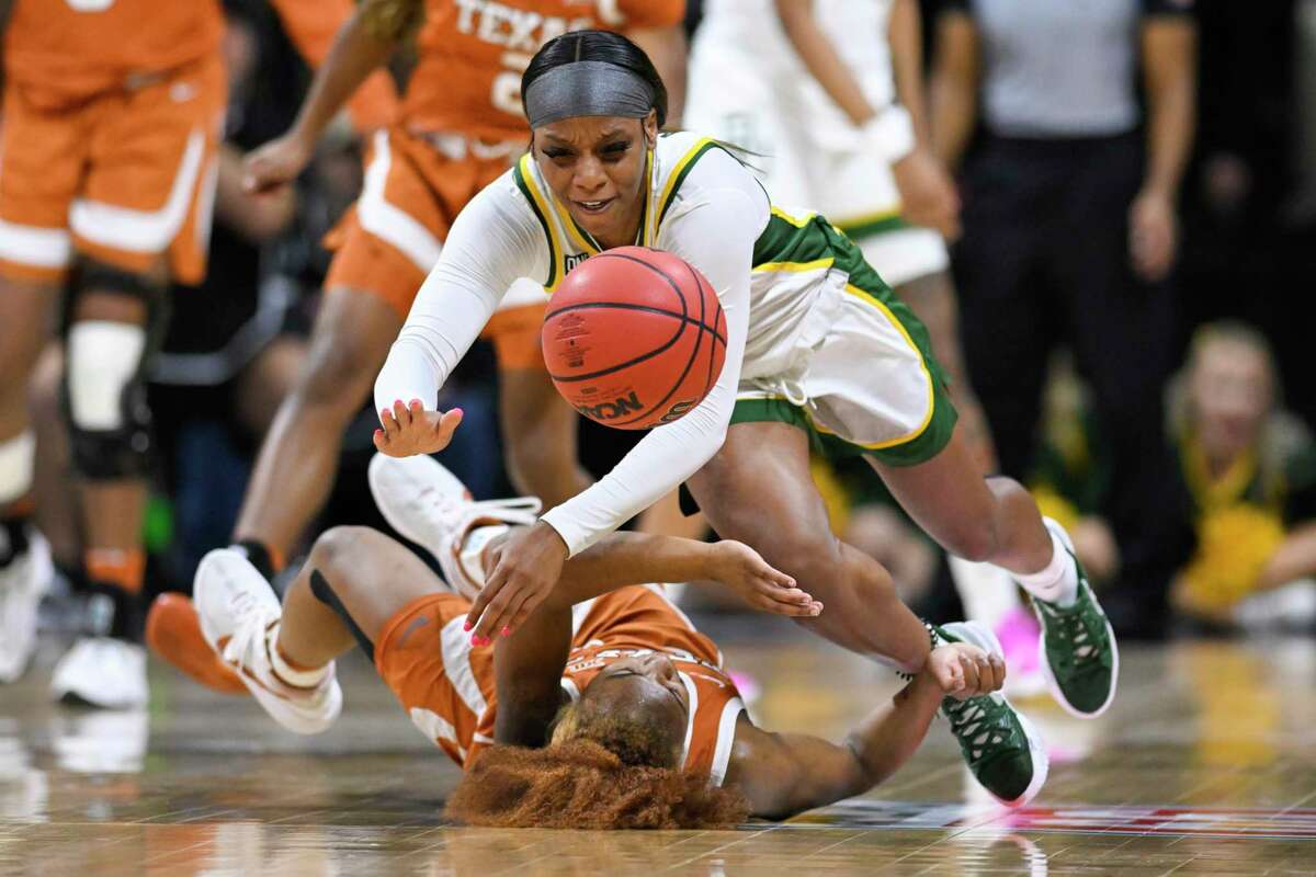 Baylor guard Ja'Mee Asberry, top, dives for a ball over Texas guard Rori Harmon during the second half of an NCAA college basketball championship game in the Big 12 Conference tournament in Kansas City, Mo., Sunday, March 13, 2022. (AP Photo/Reed Hoffmann)