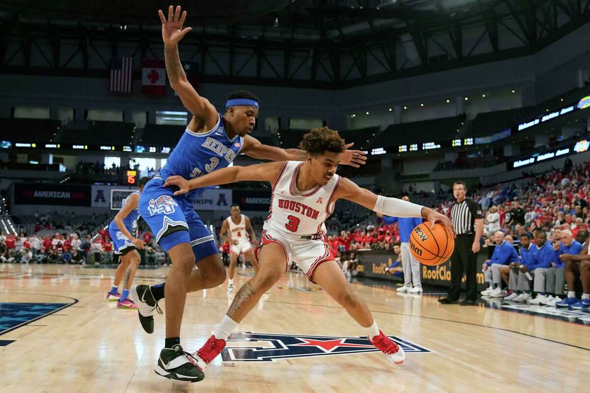 Houston guard Ramon Walker Jr. (3) tries to keep control of the ball against Memphis guard Landers Nolley II (3) during the first half of an NCAA college basketball game for the American Athletic Conference tournament championship in Fort Worth, Texas, Sunday, March 13, 2022. (AP Photo/LM Otero)