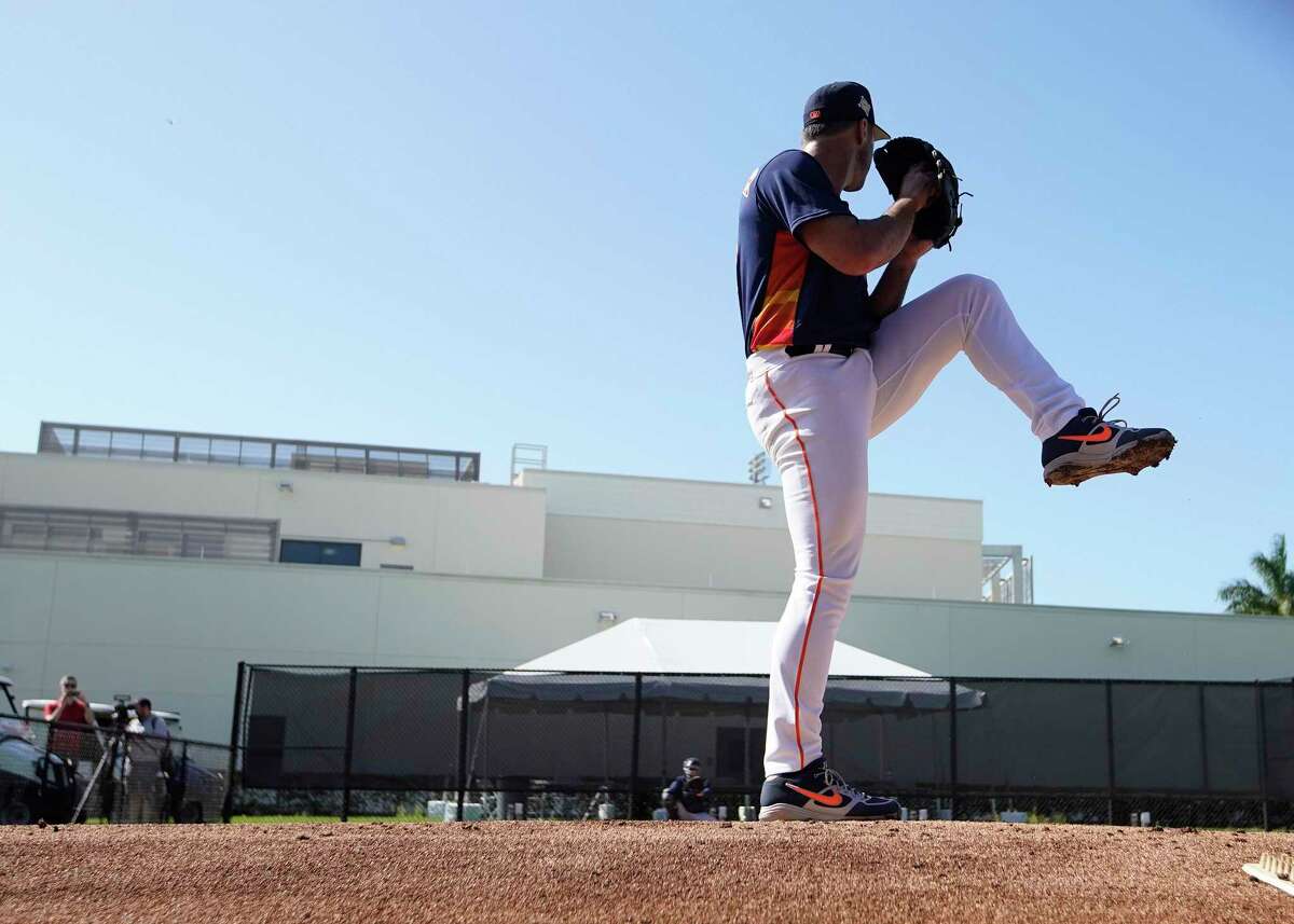 Houston Astros pitcher Justin Verlander warms up before throwing two simulated innings as Astros players reported to spring training camp after the MLB lockout ended last week at The Ballpark of the Palm Beaches on Sunday, March 13, 2022 in West Palm Beach .