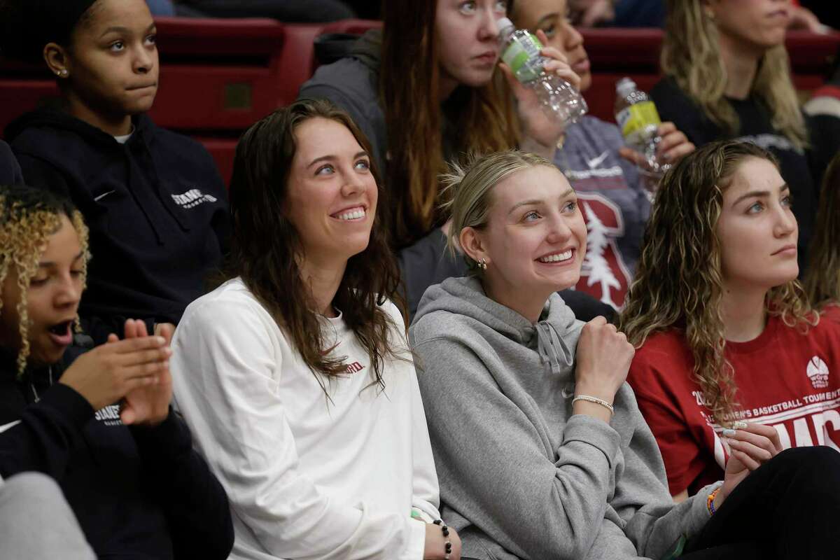 Stanford guard Lacie Hull (24) and Stanford forward Cameron Brink (22) react as they watch their bracket selection for the 2022 NCAA Tournament at Maples Pavilion in Stanford, Calif., on March 13, 2022.