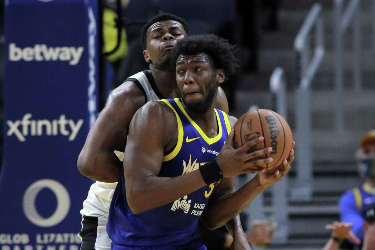 James Wiseman (33) moves to the basket defended by Michael Foster, (11) as the Santa Cruz Warriors played the G League Ignite at Chase Center in San Francisco, Calif., on Sunday, March 13, 2022.