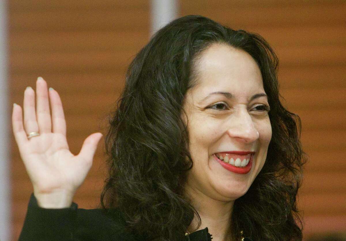 Debra Ibarra Mayfield raises her hand during a swearing-in ceremony as a newly elected Civil Court Judge on Jan. 1, 2013, in Houston. Mayfield died March 13, 2022 at 47.