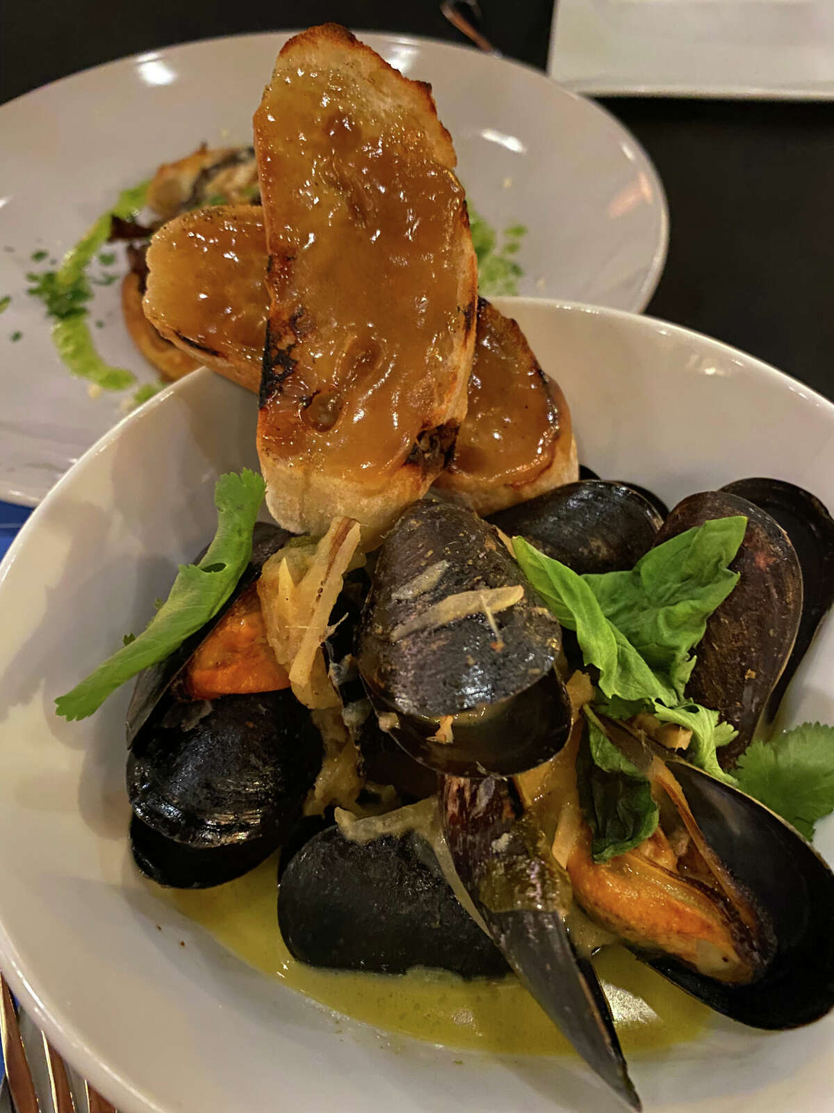 At Flight Wine Bar & Market in Glens Falls, Thai mussels are served with toast topped by coconut jam.