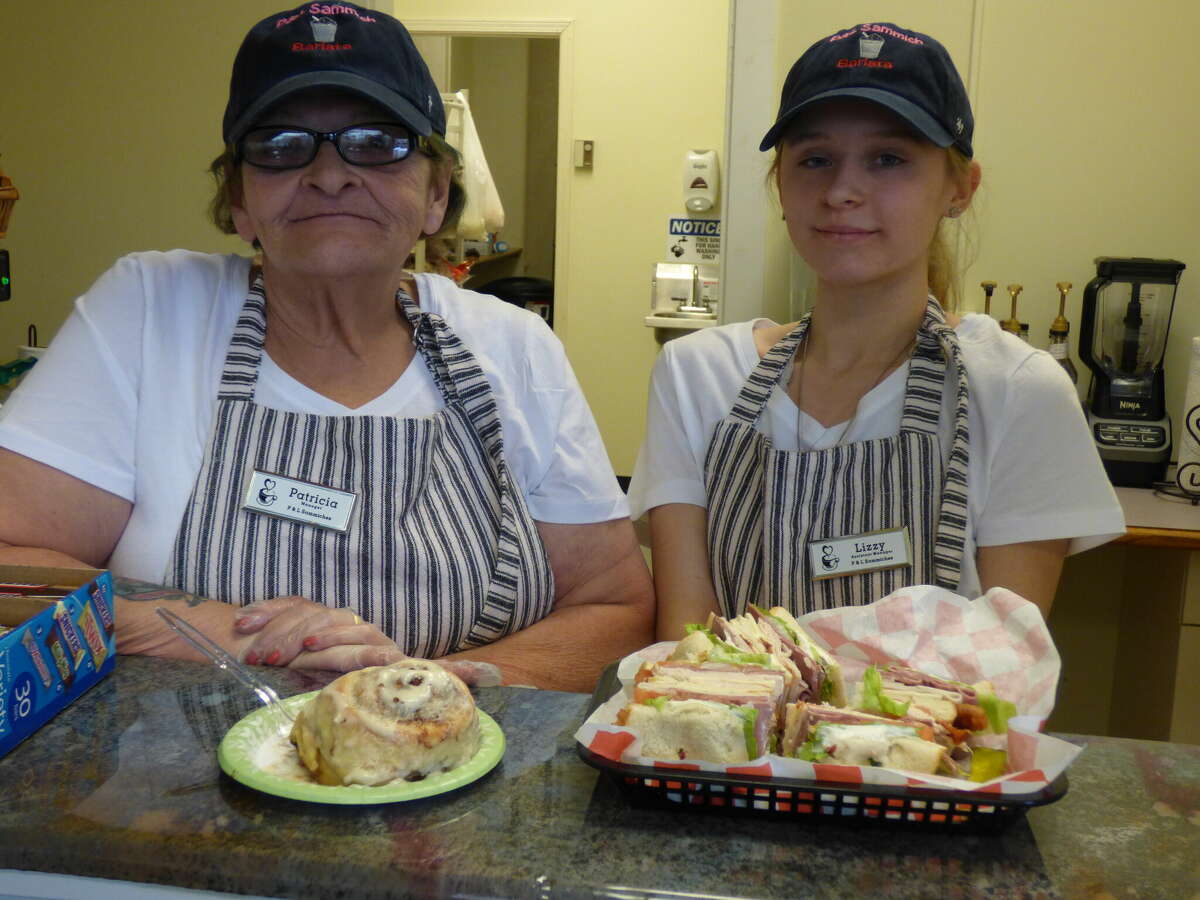 Patricia Shick (left) and her assistant, Elizabeth Carroll, work at the counter at P&L Sammich Barista.  Shick launched Manistee's new downtown sandwich shop in March.