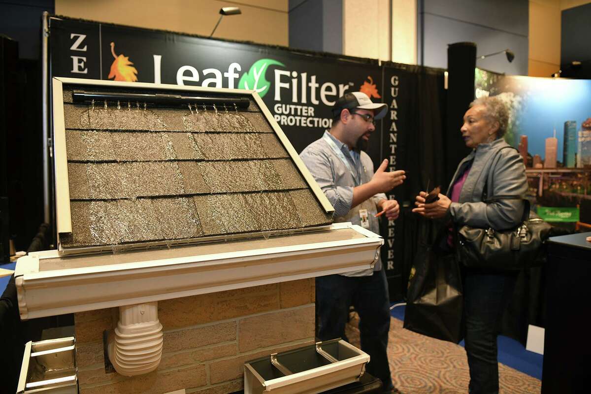 Moe Helmy, left, Leaf Filter Marketing Manager from Houston, talks rain gutters with Siddeegah Anderson, of Cypress, at the 12th annual Cy-Fair Home and Garden Show at the Berry Center in Cypress on Feb. 16, 2019.