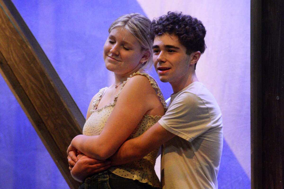 In the lead rolls of Ariel and Ren, Norah Watson and Nicholas Ferreira sing “Almost Paradise” during rehearsals for Trumbull High School Musicals’ production of “Footloose - the Musical”, in Trumbull, Conn. March 11, 2022.