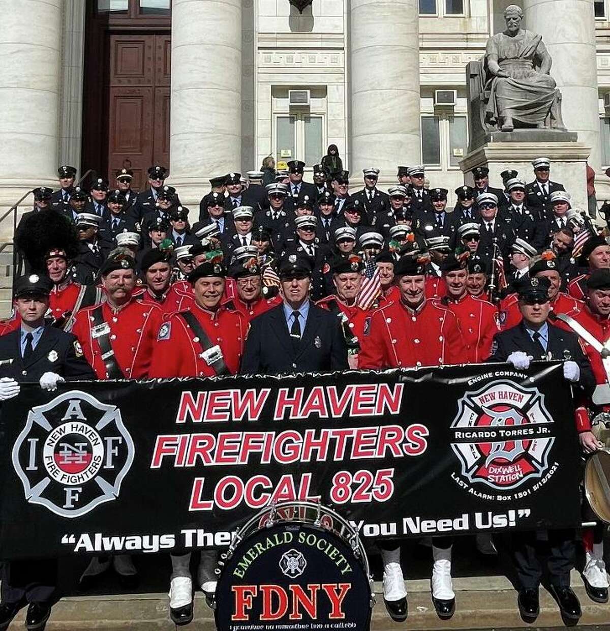 Members of the New York City Fire Department, in red, joined New Haven Fire Department members at New Haven’s St. Patrick’s Day Parade Sunday in New Haven.