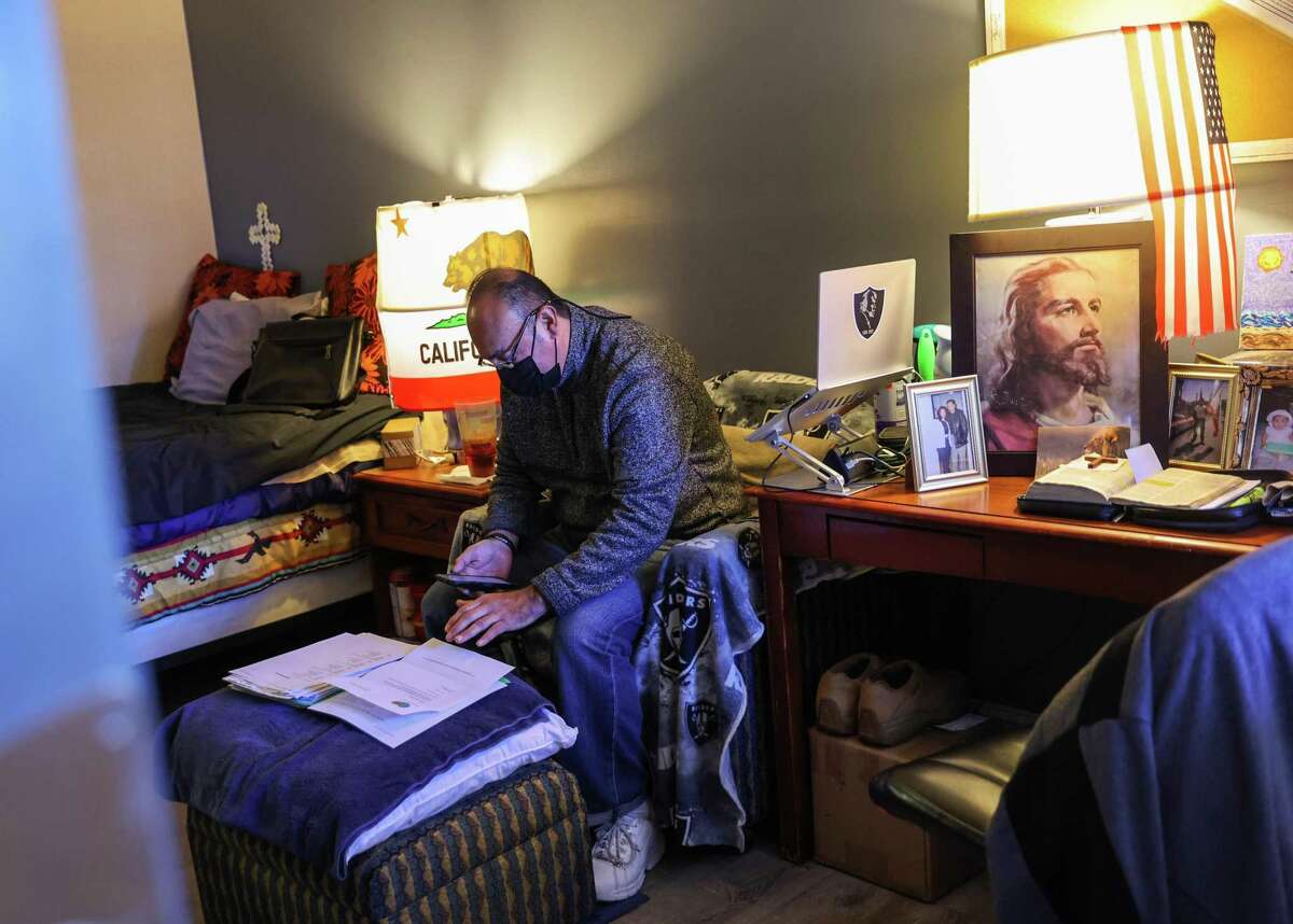 Joe Salcedo goes through his paperwork at his supportive housing complex in Half Moon Bay. San Mateo County may become the first Bay Area county to end unsheltered homelessness.