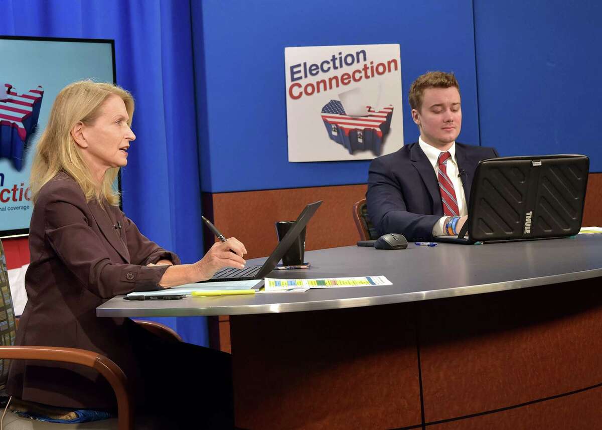 Co-anchors Jacob Schultz (right) and news personality Dr. Jacqueline Guzda (left), an associate professor of communication and media arts, in the studio on election night.