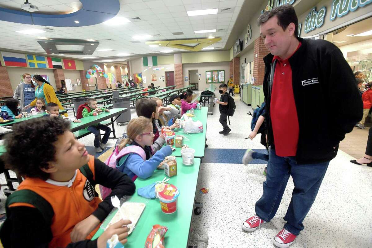 Andy McCall with the Lutcher Theater talks with students about their favorite cereals and brekafast foods as he visits during the morning meals at Regina - Howell Elementary Friday. Last week, community members visited schools throughout Beaumont ISD as part of the district's celebration of National School Breakfast Week. Photo made Friday, March 11, 2022 Kim Brent/The Enterprise