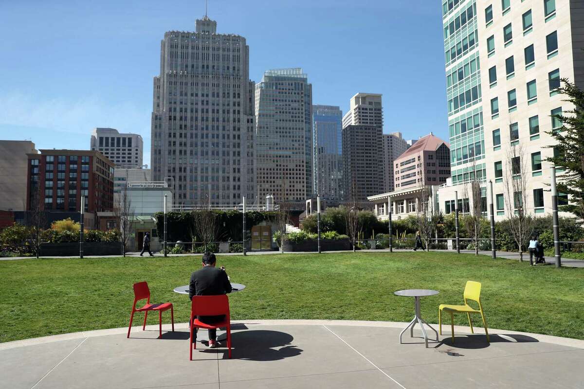 A man eats lunch in Salesforce Park in San Francisco as employees slowly return to downtown offices after two years of working remotely.