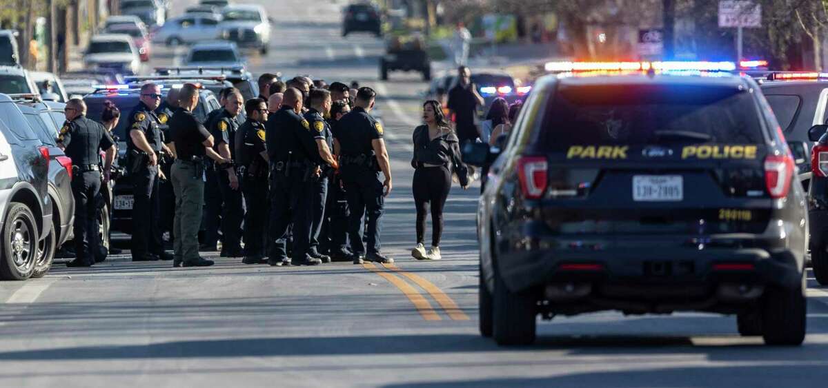 Amy Garcia, right, confronts a line of San Antonio Police Department officers on Monday near the scene of where she said her brother was shot nine times and killed by officers.