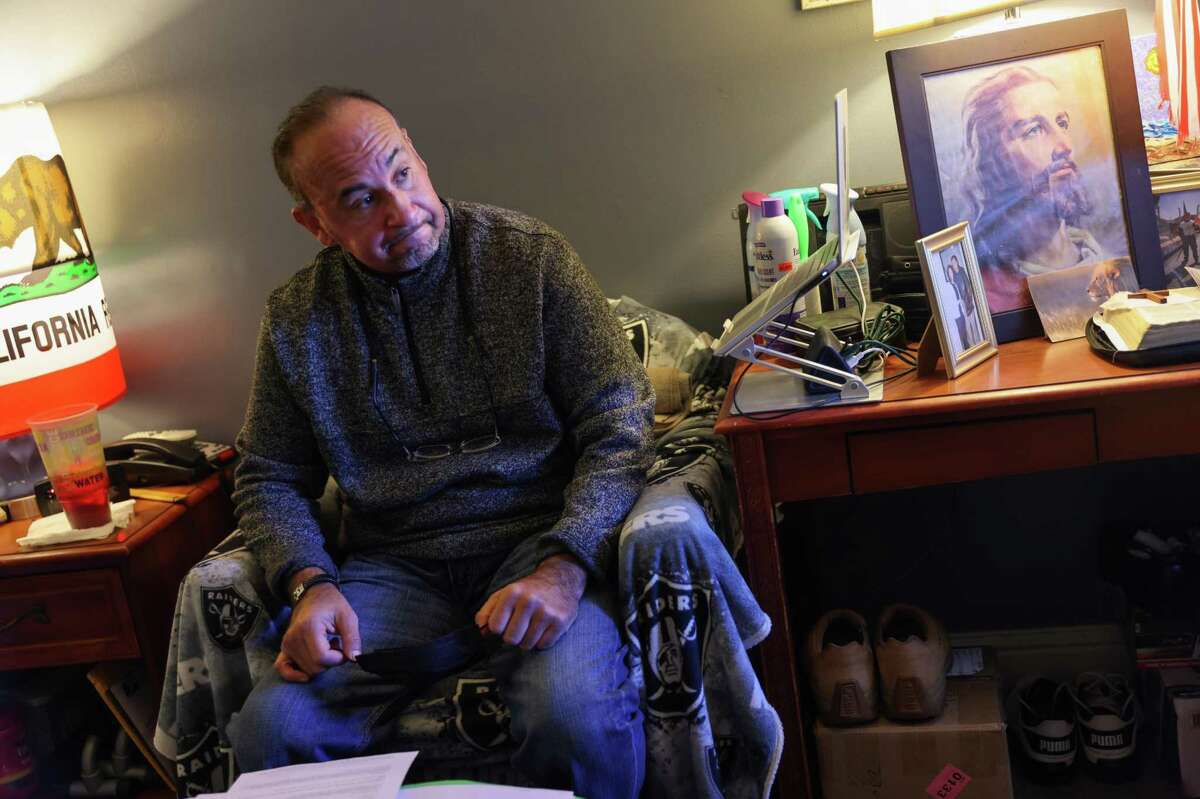 Joe Salcedo, 56, sits in his room at his supportive housing complex in Half Moon Bay, California on Thursday, March 10, 2022. San Mateo County opened its first two Project Homekey transitional and supportive housing complexes on March 10, a total of about 150 units. Joe was previously homeless and addicted to drugs in the Tenderloin but was able to get clean after a brain injury landed him in the hospital.