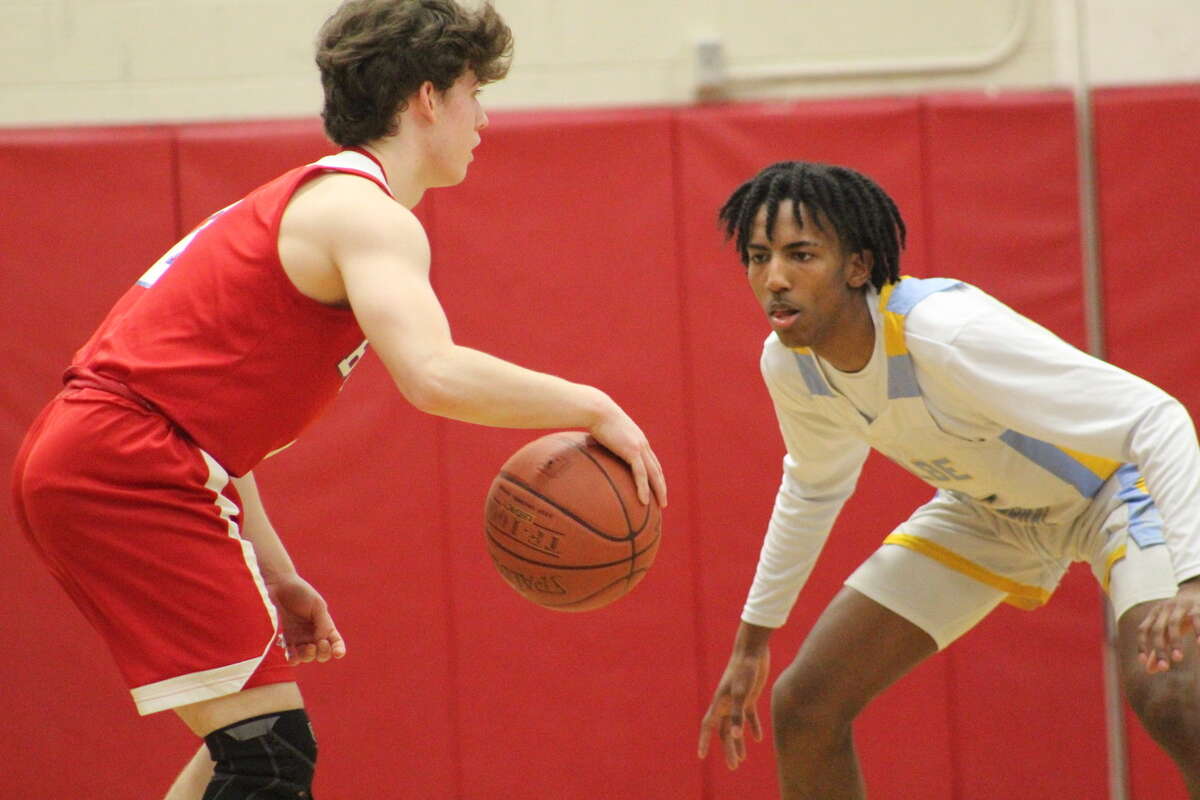 Kolbe Cathedral’s Tyrell Stalples-Santos defends against Berlin during the CIAC Division III boys basketball quarterfinals on Monday, March 14, 2022 at Warde High School in Fairfield, Conn.