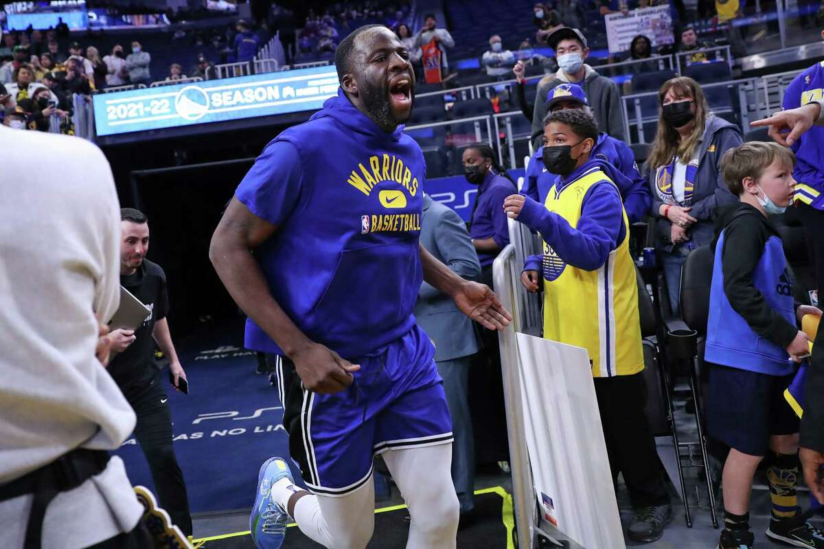Golden State Warriors' Draymond Green yells as he heads out to warm up before playing Washington Wizards in NBA game at Chase Center in San Francisco, Calif., on Monday, March 14, 2022.