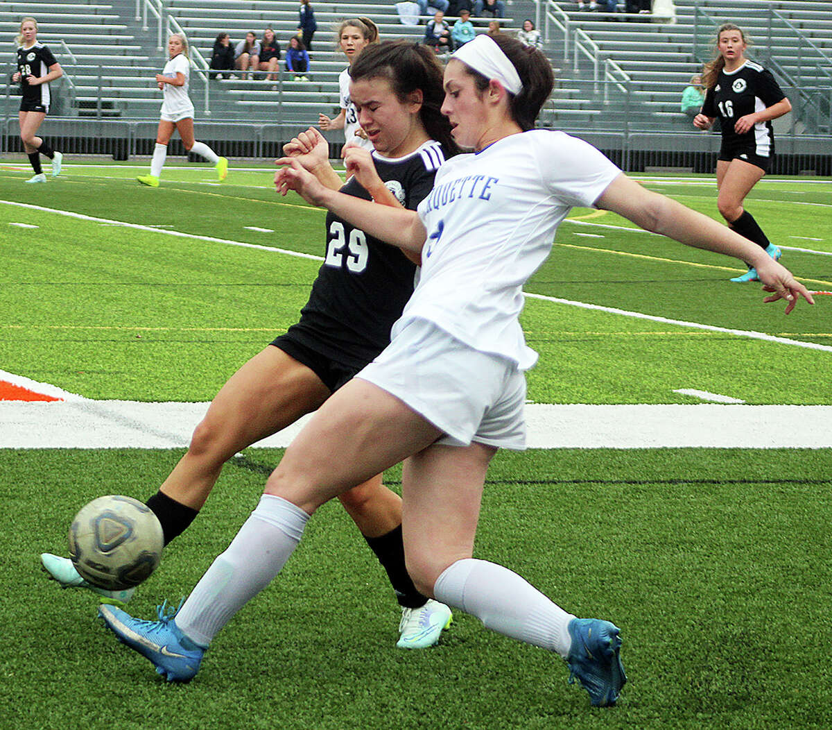 Claire Antrenner of Marquette, right, battles fort he ball with a Springfield player Monday during action in the Metro Cup Tournament at Edwardsville.