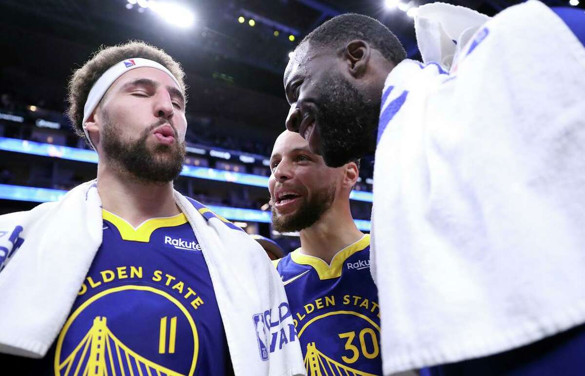 Golden State Warriors' Klay Thompson, Stephen Curry and Draymond Green relish in being reunited after Warriors' 126-112 win over Washington Wizards in NBA game at Chase Center in San Francisco, Calif., on Monday, March 14, 2022.