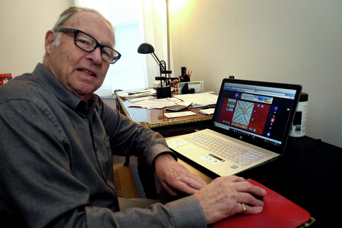 Mike Davis sits at his computer to play online Scrabble in his home in Norwalk, Conn. March 14, 2022.