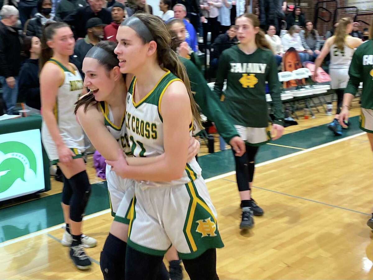 Holy Cross' Maya Zaccagnini (21 points) is hugged by a teammate after the Crusaders defeated Valley Regional 57-50 in the Class M semifinals Monday at Maloney.