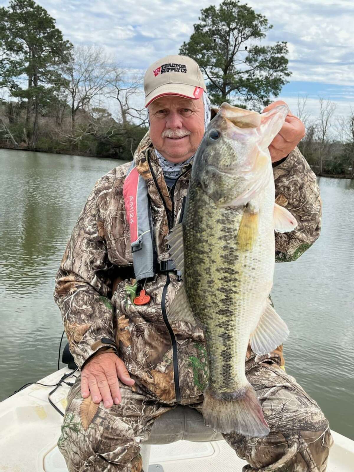 Fishing guide Butch Terpe holds an 8.24 pound black bass he caught recently on a six inch plastic worm.