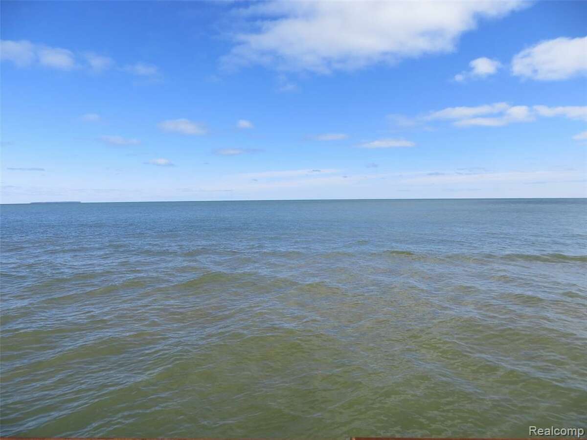 This home in Sand Point is listed at $688,000 and features three stores accessible by a spiral staircase with views of Saginaw Bay/Lake Huron. There are five bedrooms, an adjacent lagoon for boating access to the lake and three living rooms.