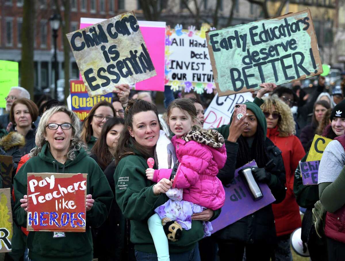 Child care workers, educators and parents rally on the New Haven Green for more pay for workers and financial assistance for parents on March 15, 2022.
