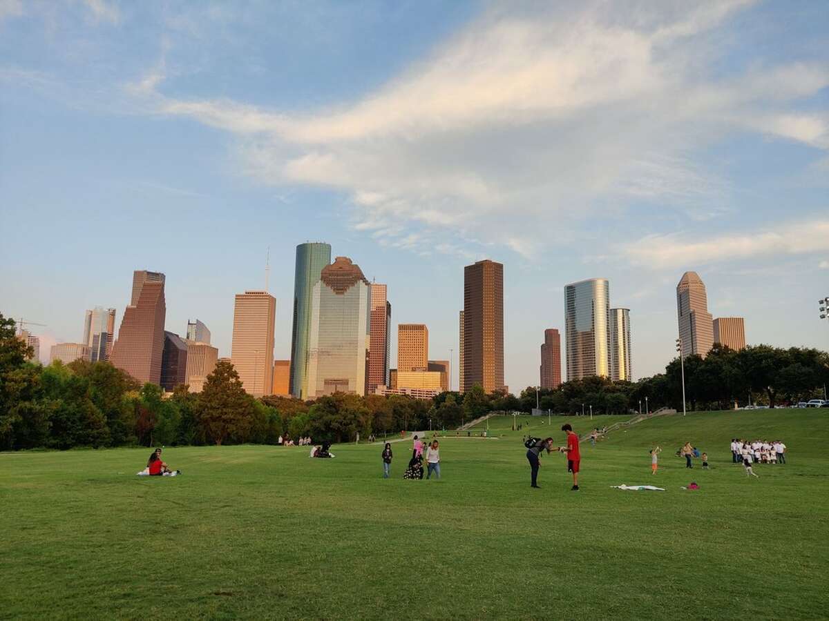 Visitors picnicking and playing at Buffalo Bayou Park.