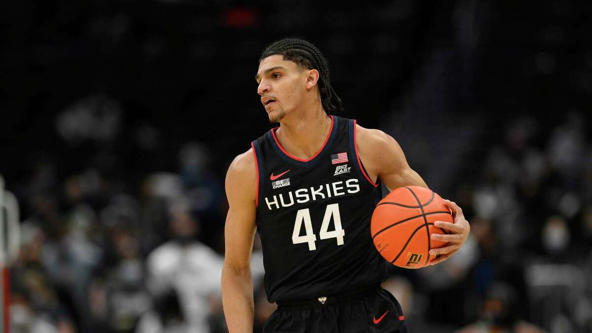 Photos clockwise from top, UConn guard Andre Jackson (44) in action during the first half of an NCAA college basketball game against Georgetown, Sunday, Feb. 27, 2022, in Washington. Connecticut won 86-77. (AP Photo/Nick Wass)