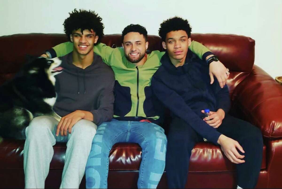 UConn men's basketball sophomore Andre Jackson (left) with older brother Tyler (center) and younger brother Marcus (right)