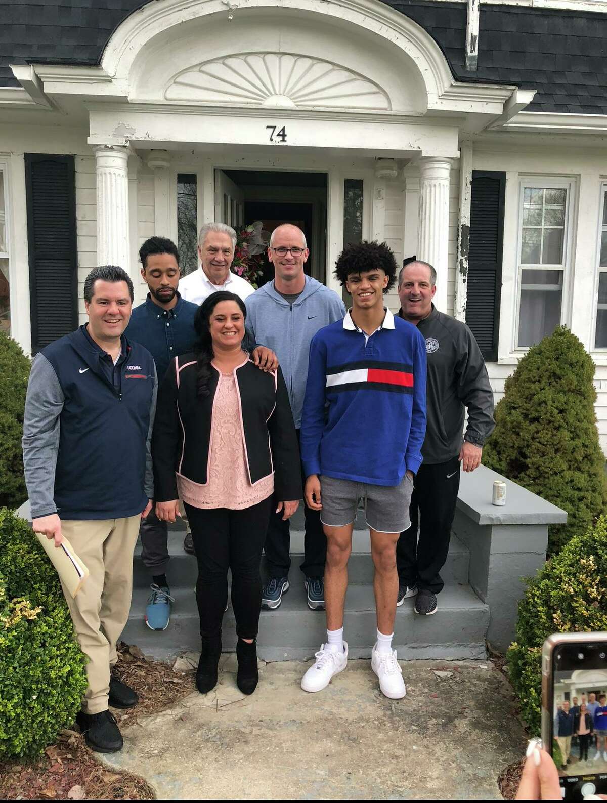 UConn men's basketball sophomore Andre Jackson with his mother, Tricia Altieri; his grandfather, Richard Altieri; Tricia's longtime partner, John; UConn coach Dan Hurley, UConn assistant Tom Moore, Albany Academy coach Brian Fruscio.