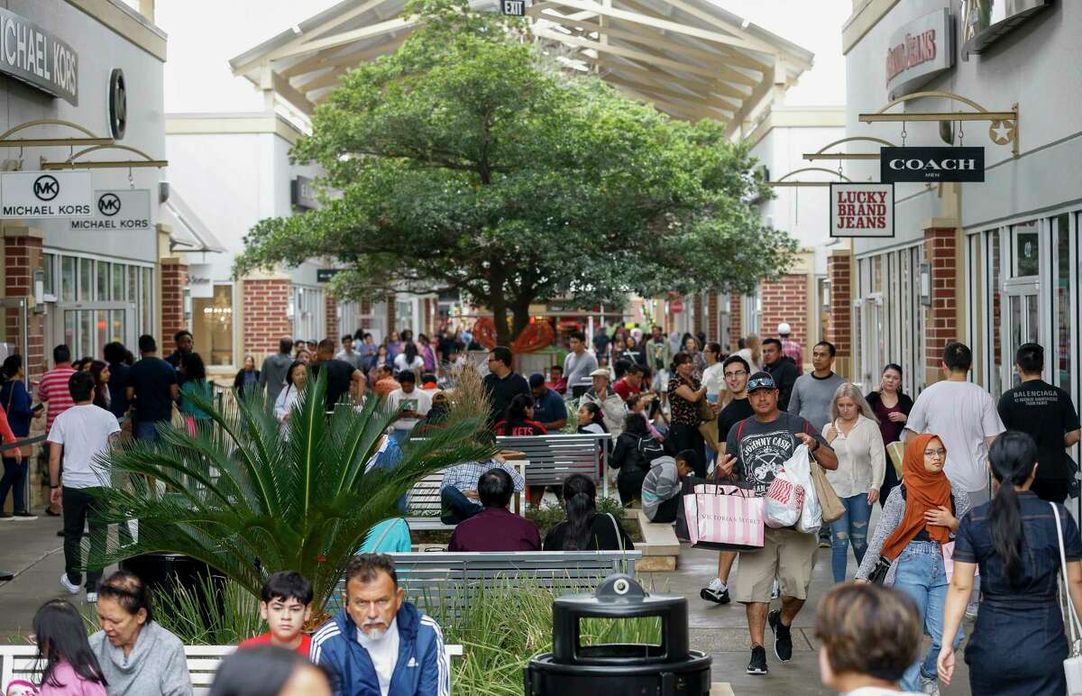 People shop for Black Friday deals at the Houston Premium Outlets Friday, Nov. 29, 2019, in Cypress, Texas.