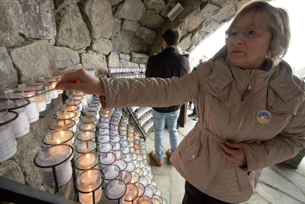 Judy Dougherty, director of the Franciscan Center, lights a candle in The Grotto during a vigil to pray for peace in Ukraine with members of the Siena College community on the Siena College campus Tuesday, March 15, 2022 in Colonie, N.Y.