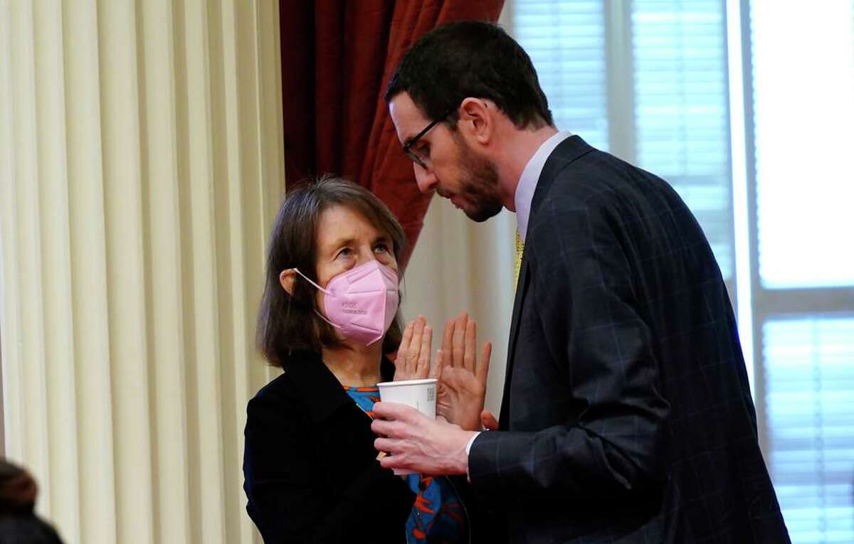 State Sen. Nancy Skinner, D-Berkeley, talks with state Sen. Scott Wiener, D-San Francisco, during the Senate session at the Capitol in Sacramento, Calif., on March 14, 2022. The California Legislature approved Skinner's bill effectively overturning a recent court ruling requiring UC Berkeley to reduce enrollment.