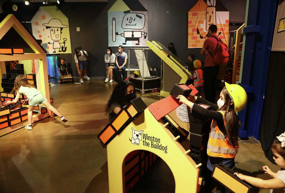 Mackenzie Zaiontz, 4, of San Marcos, dresses in a hard hard and safety vest as she and her older sibling, Aleeha, play in of the many interactive exhibits at the DoSeum as spring break went into full effect Monday. The museum was expected to reach full capacity each day this week as students enjoy a week away from school. Some families are visiting from outside San Antonio.
