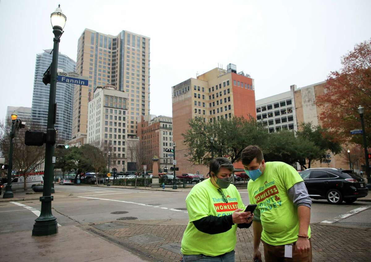 Jess DiManno and Jonathan Danforth decide what part of the city to head to next while doing the annual homeless count on Tuesday, Jan. 25, 2022, in Houston.