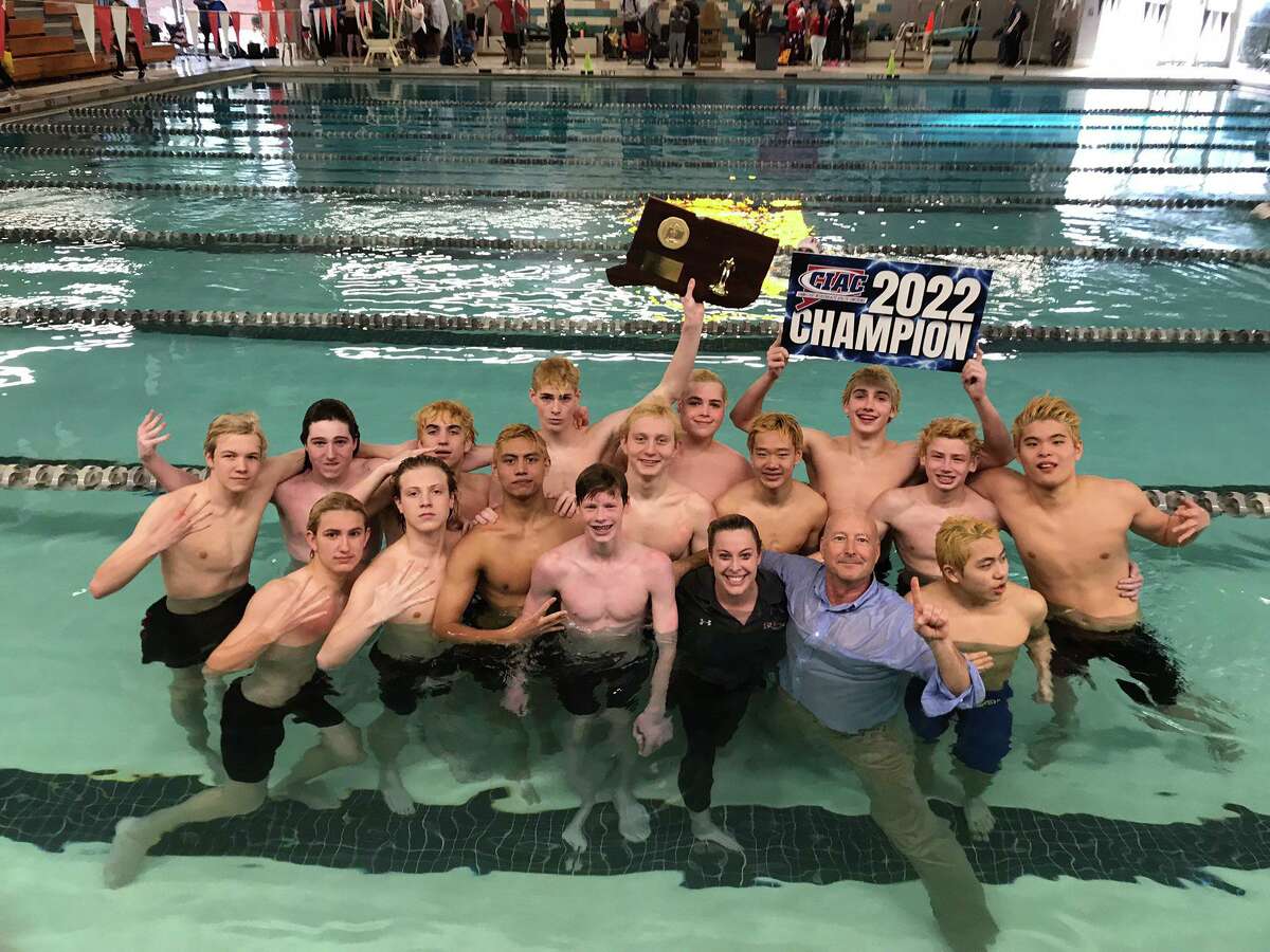 Members of the New Canaan boys swimming and diving team celebrate after winning the Class L title at Cornerstone Aquatics Center Tuesday, March 15, 2022.