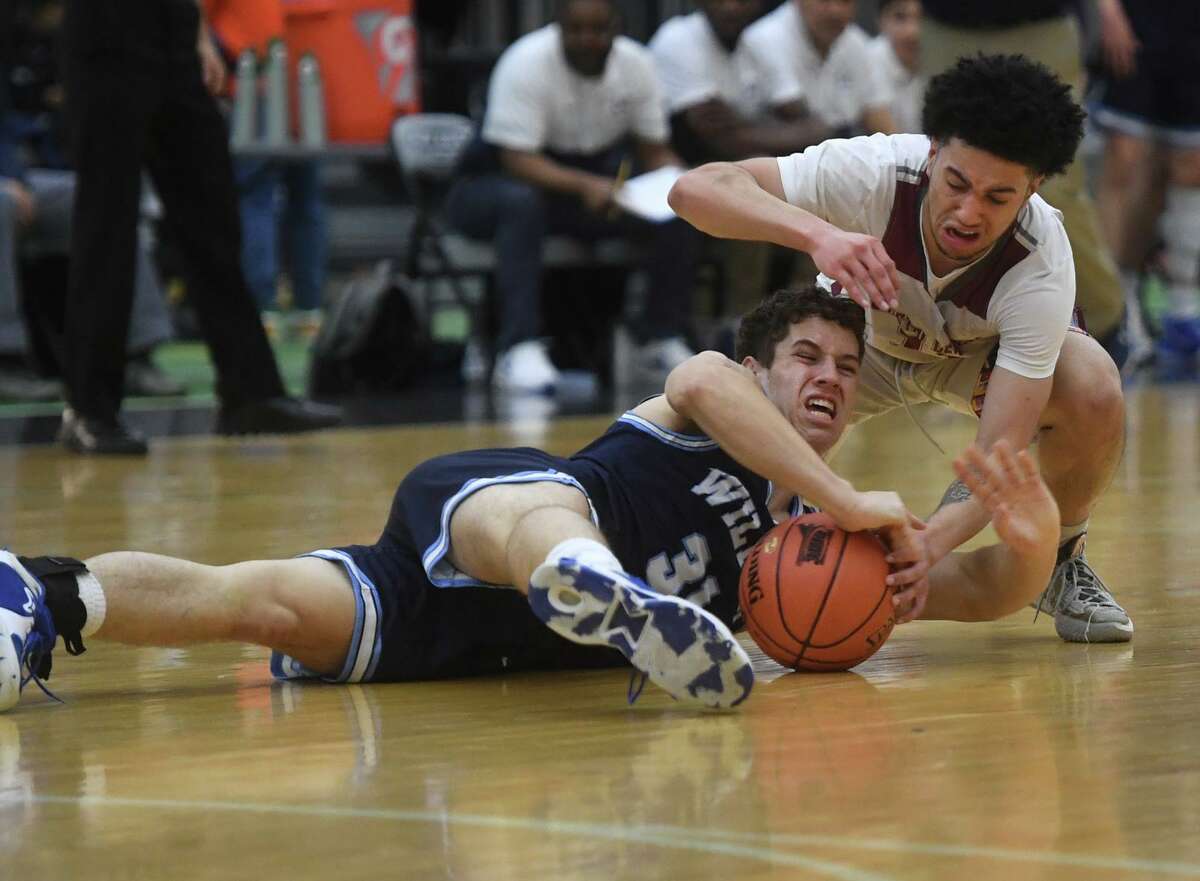 Wilton's Maxwell Jarvie dives for a loose ball with Bristol Central's Steven Alseph during the CIAC Division II boys basketball semifinals at the Floyd Little Athletic Center in New Haven, Conn., on Tuesday, March 15, 2022.