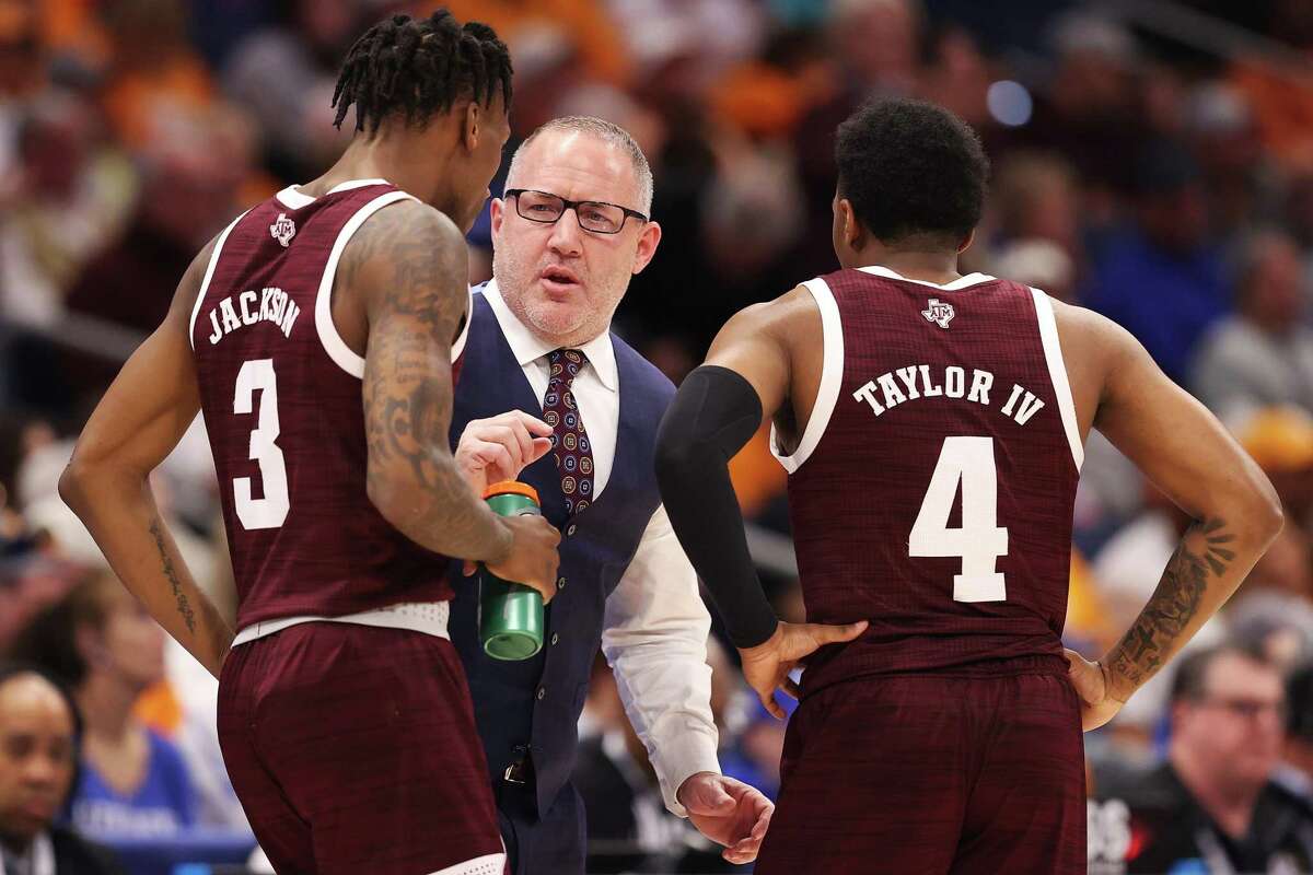 TAMPA, FLORIDA - MARCH 13: Head coach Buzz Williams of the Texas A&M Aggies talks with Quenton Jackson #3 and Wade Taylor IV #4 in the first half against the Tennessee Volunteers in the Championship game of the SEC Men's Tournament at Amalie Arena on March 13, 2022 in Tampa, Florida. (Photo by Andy Lyons/Getty Images)