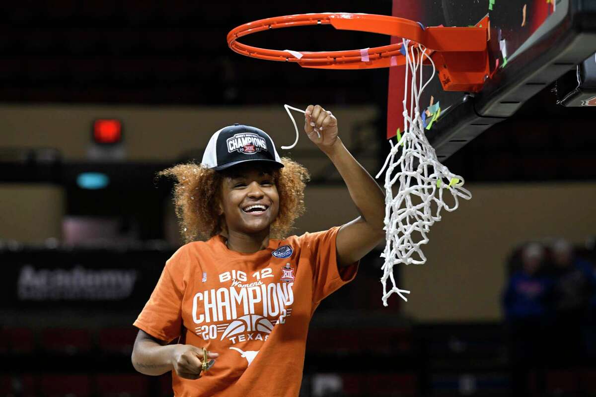 Texas guard Rori Harmon cuts down part of the net after they beat Baylor in the Big 12 tournament championship game during an NCAA basketball game in Kansas City, Mo., Sunday, March 13, 2022. (AP Photo/Reed Hoffmann)