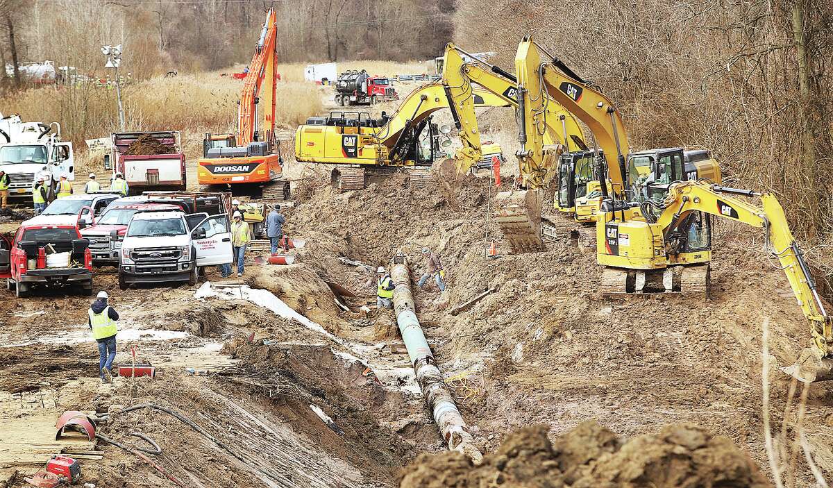 John Badman|The Telegraph Scores of workers were on the site of the pipeline leak Tuesday near the intersection of Illinois 143 and 159 in Edwardsville. Late Tuesday Marathon officials said the pipeline had been repaired; cleanup work continues.