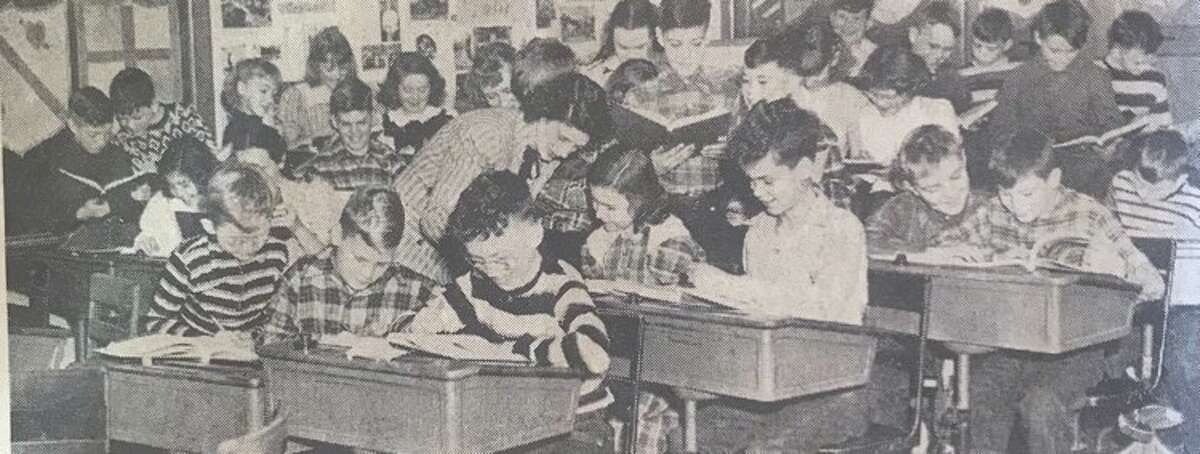 Carpenter School's sixth grade class works on their vocabulary, including, foreground from left, Jimmy Hauffer, Bob Sweet, Lyle Nagle. Teacher Claire Reynolds works with student Janet Burd, who is seated next to Rex Chase, and in front of Dick Clark and Marvin Miller. January 1949