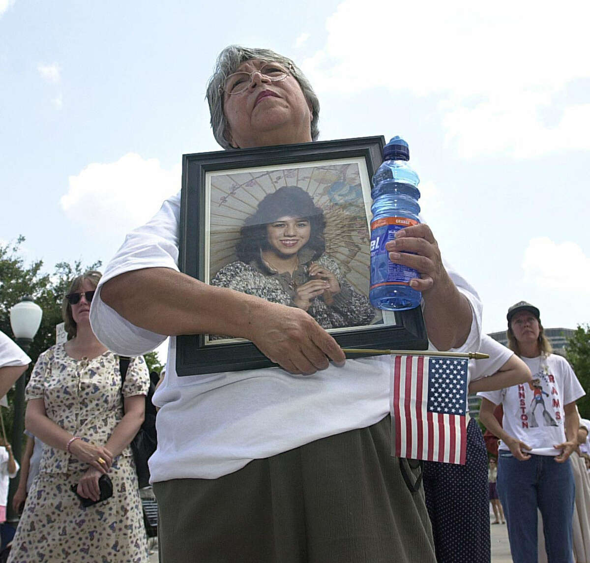 Margaret Espinoza, of San Antonio holds the image of her daughter Erica Espinoza, who was an innocent bystander in a drive-by-shooting in 1992, during the Million Mom March in Austin.