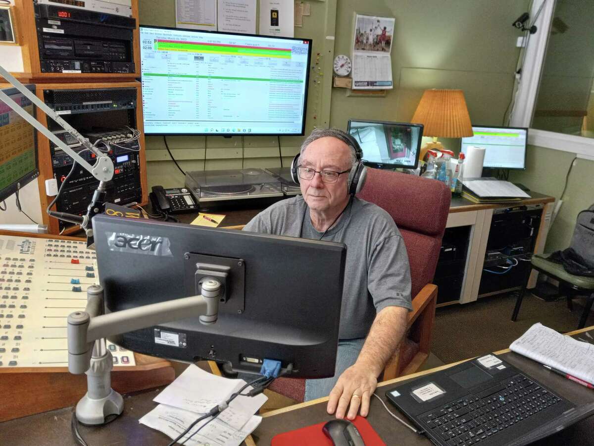 Joel Benson, host of “Unhinged” works in the booth during his Tuesday afternoon show. WAPJ, Torrington's community radio station, is celebrating its 25th anniversary on St. Patrick's Day.
