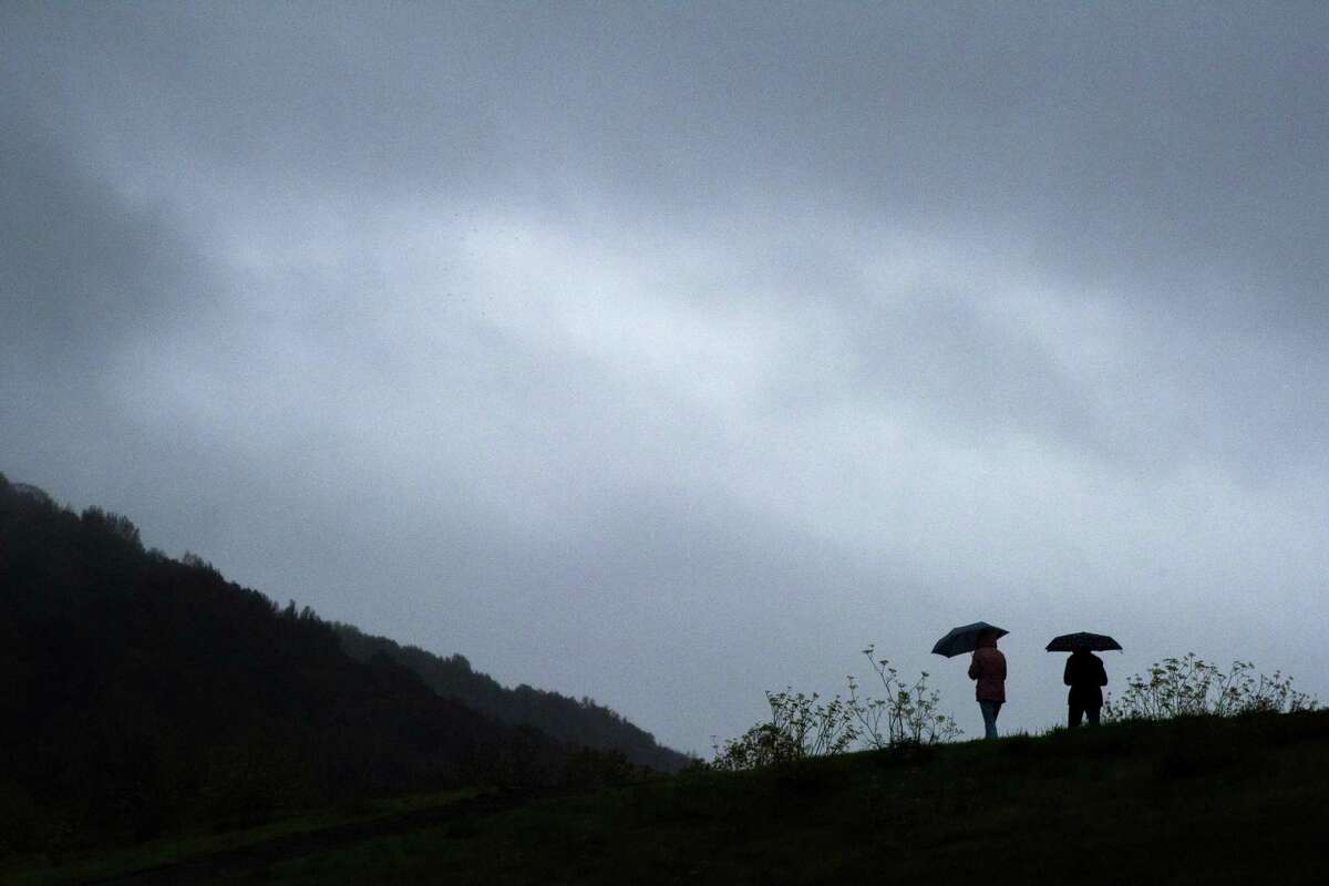 A couple walks in the rain along the Spring Creek Trail in Santa Rosa, Calif. The Bay Area is running out of chances to beat back the start of Northern California’s fire season, after an historically dry rainy season. Luckily, rain is on tap for the weekend.