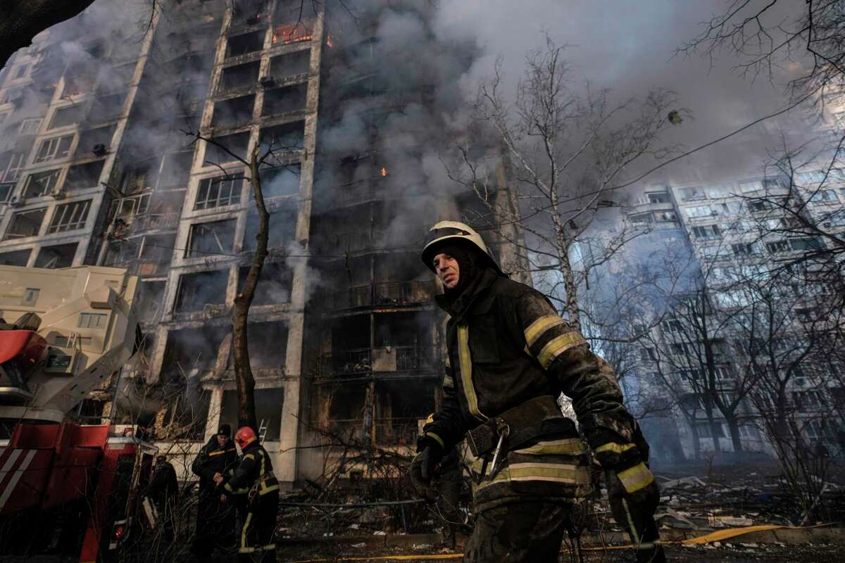 A firefighter walks outside a destroyed apartment building after a bombing in a residential area in Kyiv, Ukraine, Tuesday, March 15, 2022. Russia's offensive in Ukraine has edged closer to central Kyiv with a series of strikes hitting a residential neighborhood as the leaders of three European Union member countries planned a visit to Ukraine's embattled capital. (AP Photo/Vadim Ghirda)