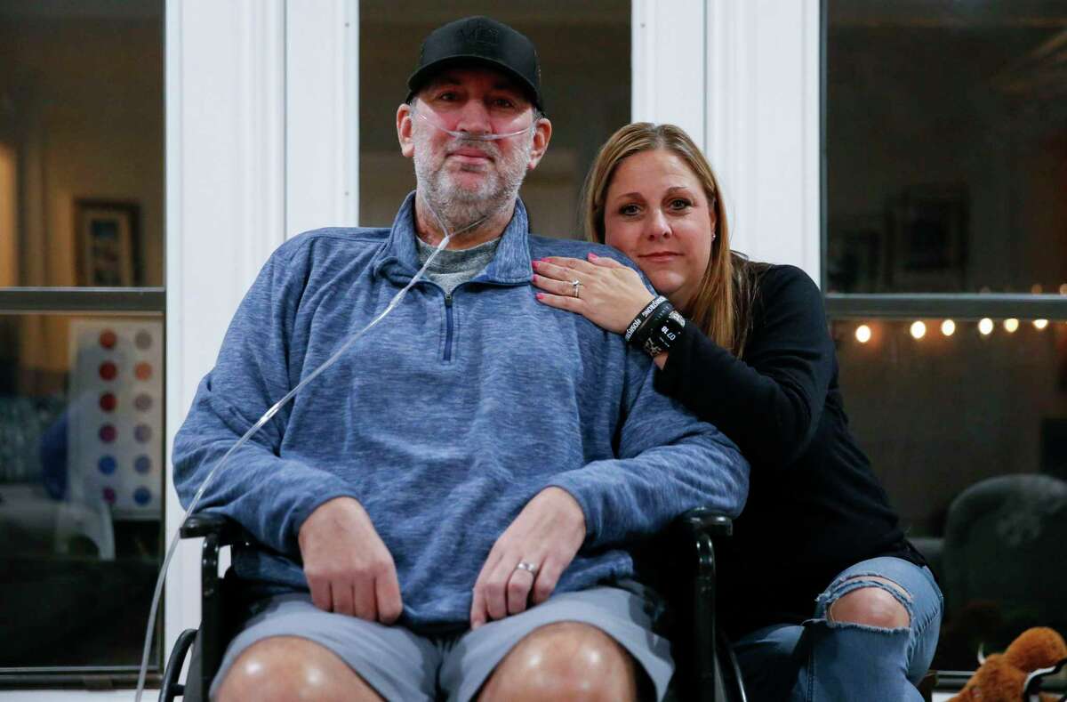 Josh Welch and his wife Emily pose for a portrait on Thursday, Feb. 24, 2022 in Plano. Josh was hospitalized with COVID-19 for six months and returned home on Feb. 4, 2022.