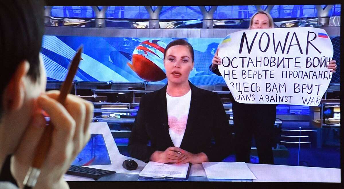 Marina Ovsyannikova, an editor at state-controlled Channel One, Russia’s most-watched evening news broadcast, was detained after she ran on to the set on March 15 holding a sign that says "No War,” condemning Moscow's military action in Ukraine. (-/AFP via Getty Images/TNS)