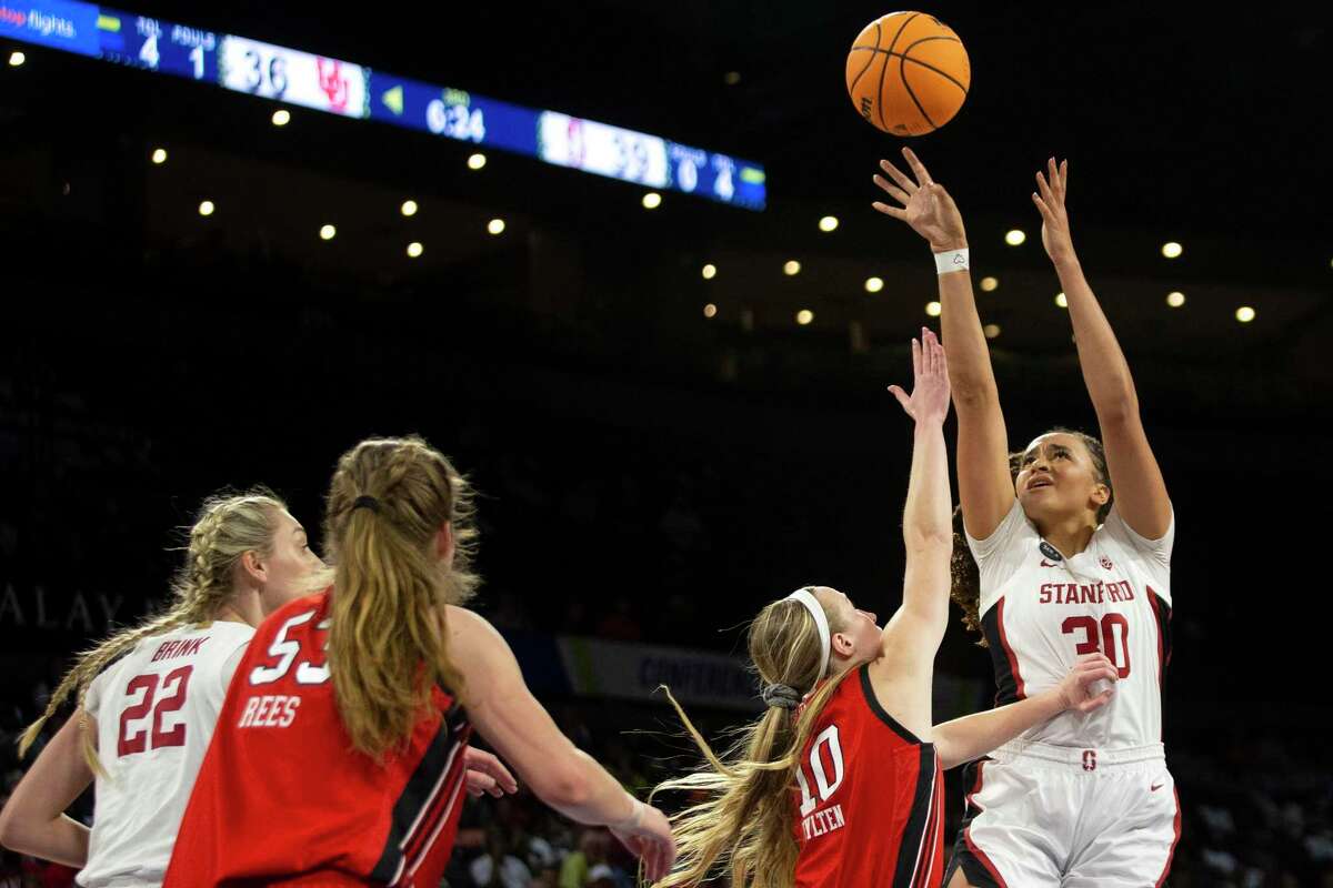Stanford guard Haley Jones (30) shoots against Utah guard Dru Gylten (10) during the second half of an NCAA college basketball game for the Pac-12 tournament championship Sunday, March 6, 2022, in Las Vegas. At left are Stanford forward Cameron Brink (22) and Utah forward Kelsey Rees (53). (AP Photo/Ellen Schmidt)