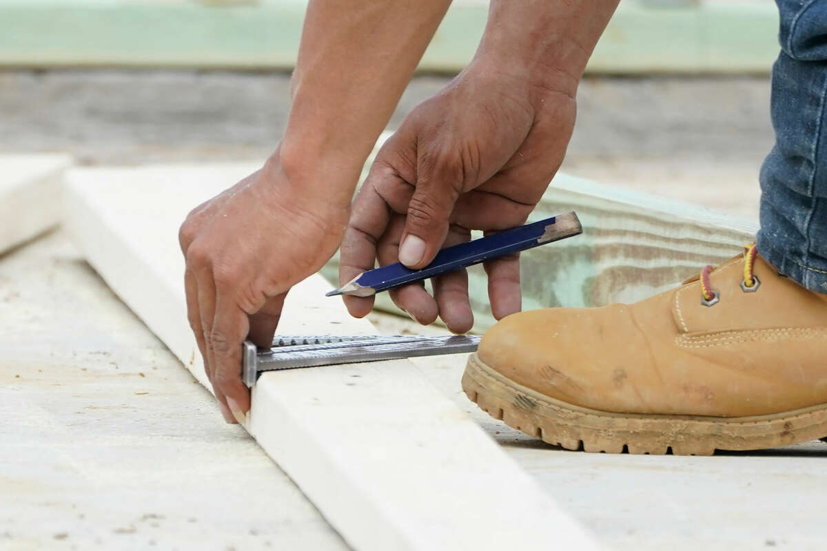 A worker measures uses a rafter to mark a beam for trimming at a new housing site. If getting ready to buy a house, you've probably been saving for the down-payment and other closing costs. A home improvement fund can help ensure your newly purchased house is a well-functioning, comfortable home.