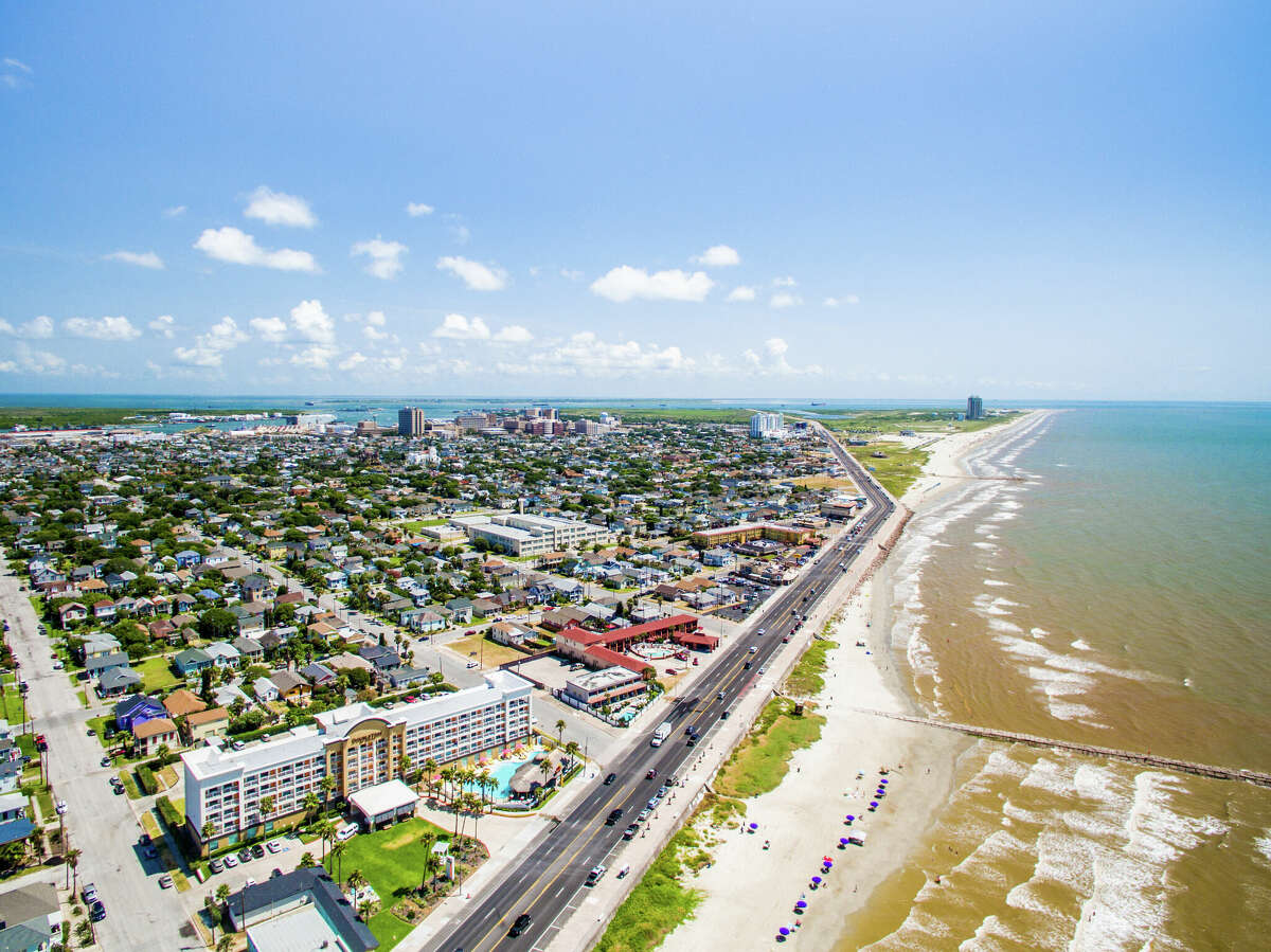 An aerial view of Galveston's historic seawall that spans over 10 miles and offers some of the best beaches, restaurants, lodging and more in Texas. 